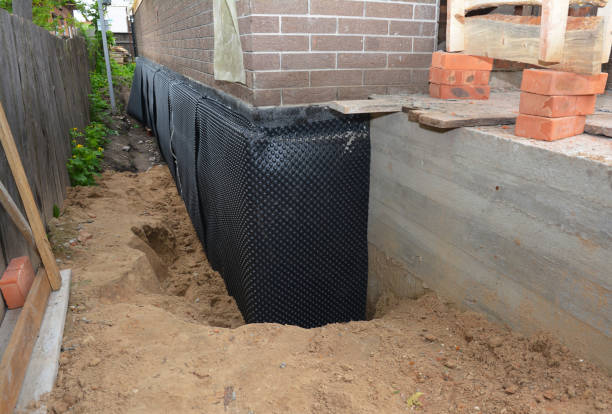 SJ Waterproofing Pros technician performing targeted Interior Drainage System assessment in Fremont, WI
